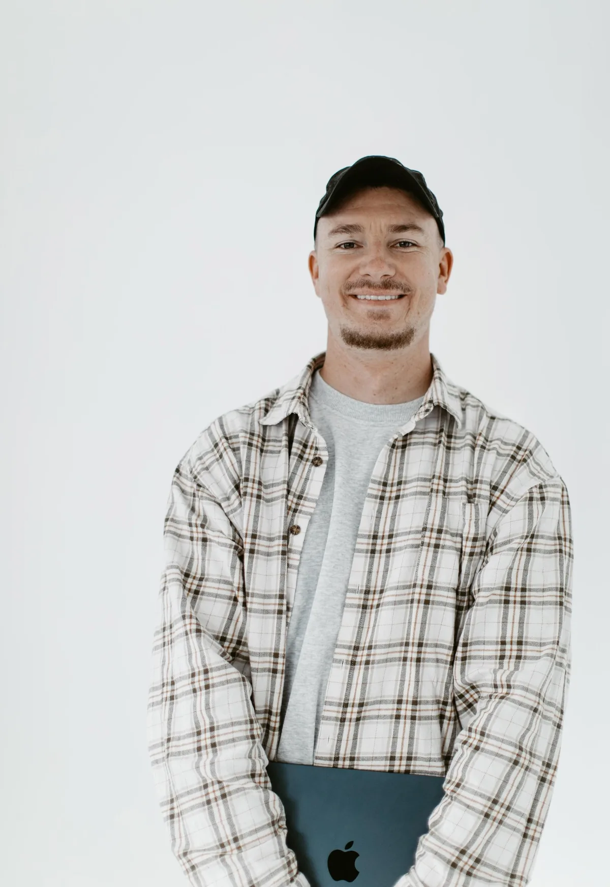 Sam Colthorpe holding a laptop in the studio, Marketing Agency Newcastle