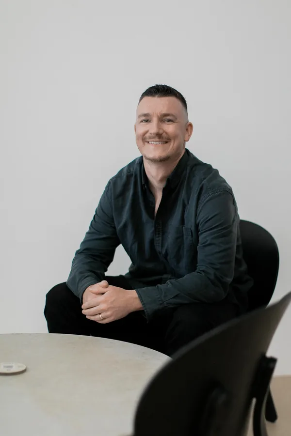 Sam Colthorpe seated at a table, Business Brother, Marketing Agency Newcastle